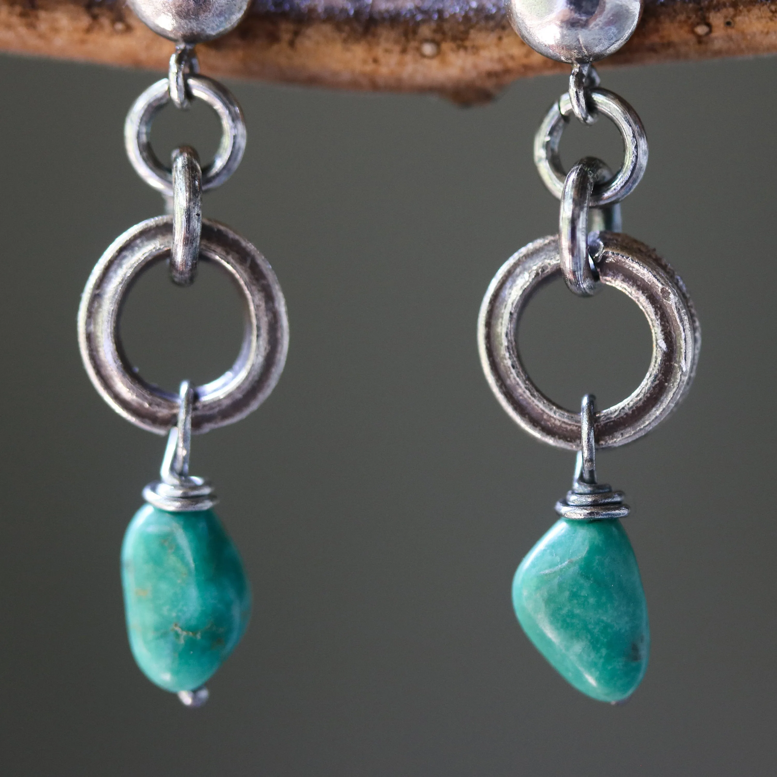 Blue turquoise earrings in freeform shape with silver ring loops and sterling silver stud style
