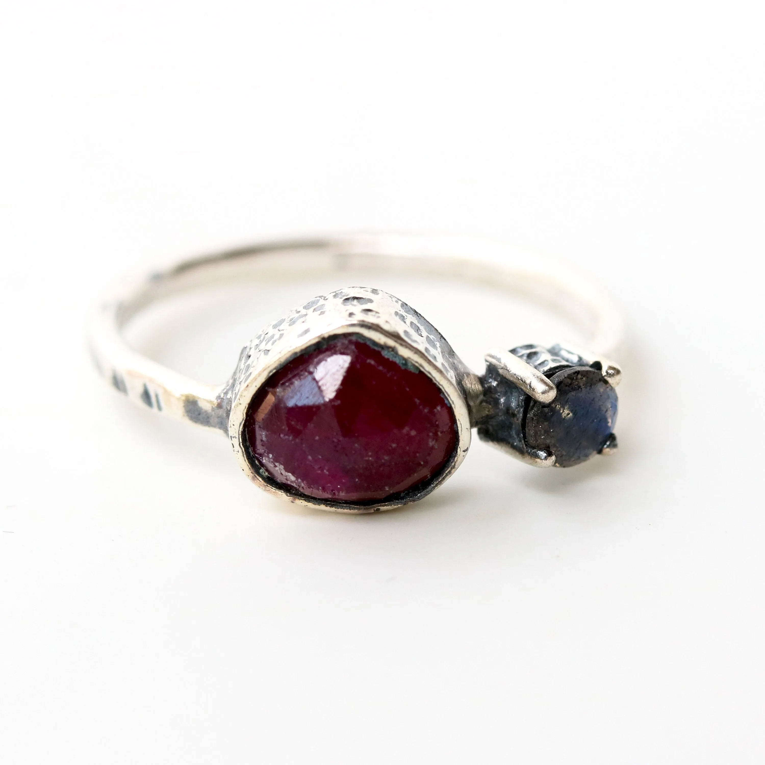 Deep red ruby ring in silver bezel setting and tiny round labradorite with sterling silver texture design band