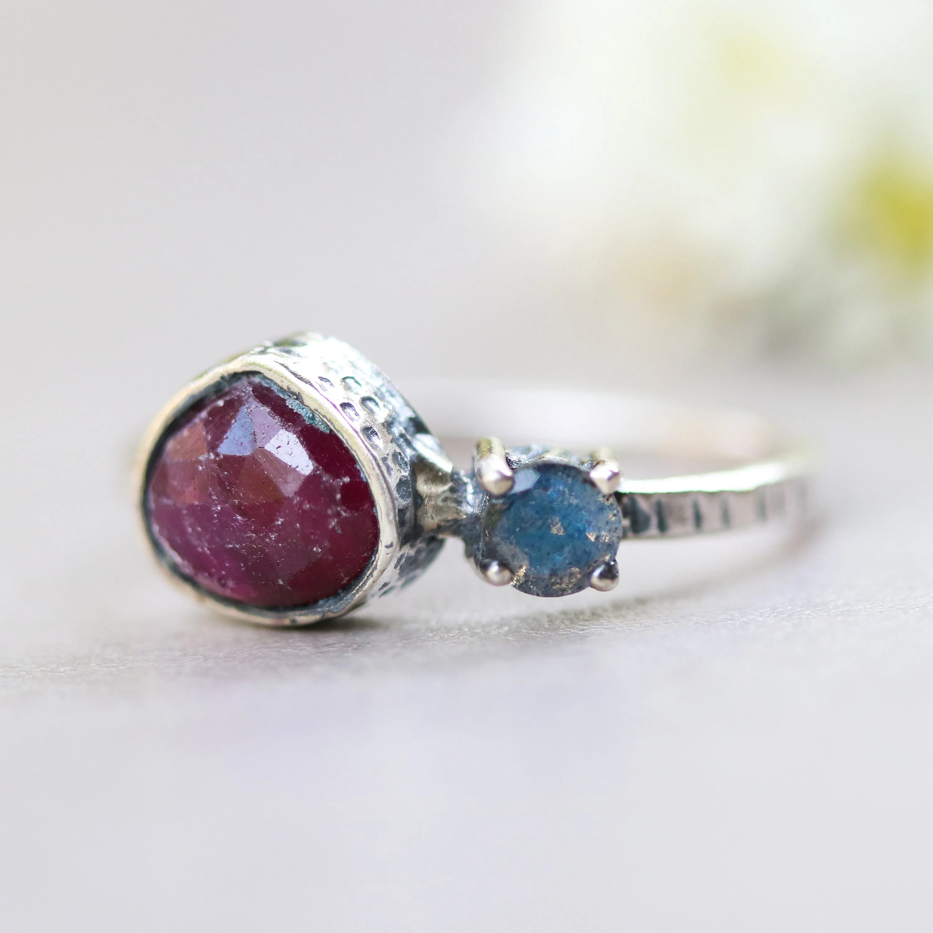 Deep red ruby ring in silver bezel setting and tiny round labradorite with sterling silver texture design band