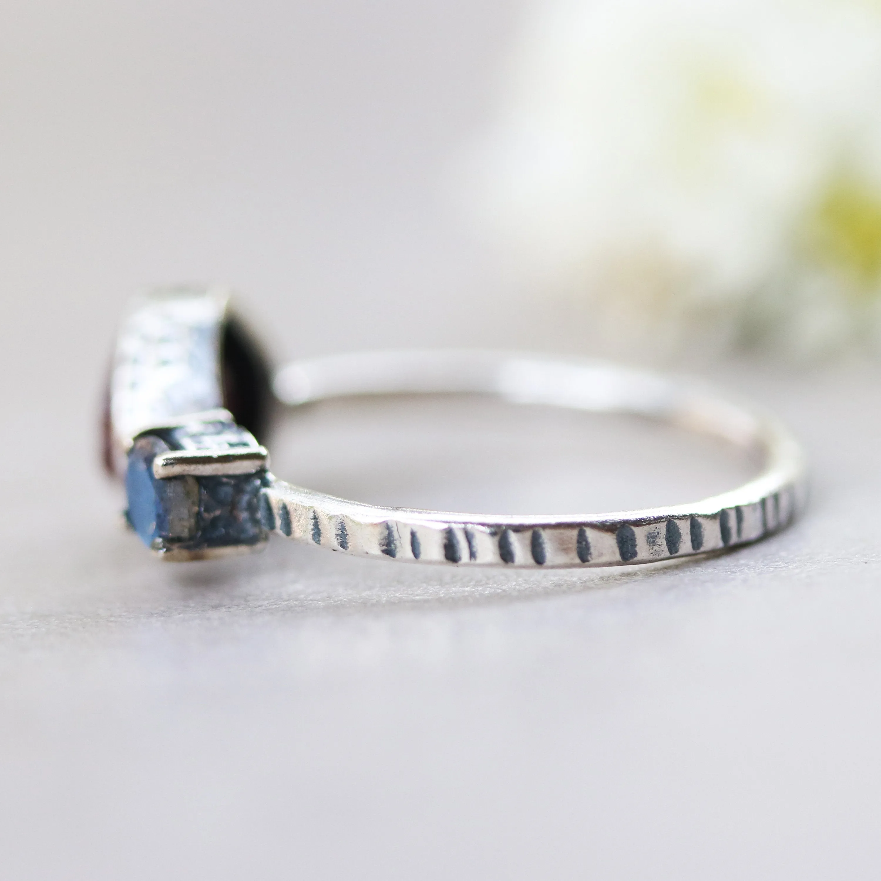 Deep red ruby ring in silver bezel setting and tiny round labradorite with sterling silver texture design band