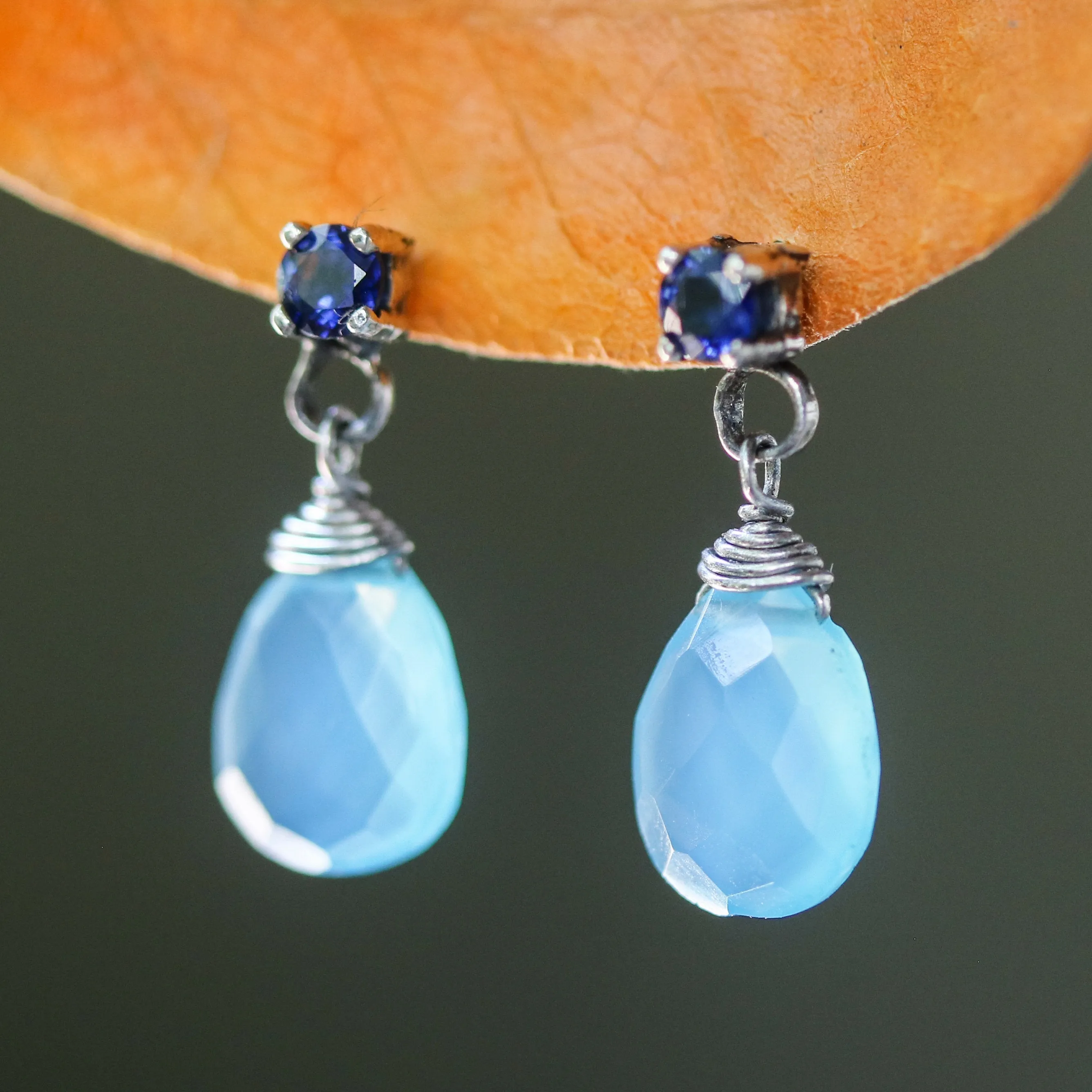Dyed blue chalcedony teardrop faceted earrings with tiny blue sapphire on the top and sterling silver stud style