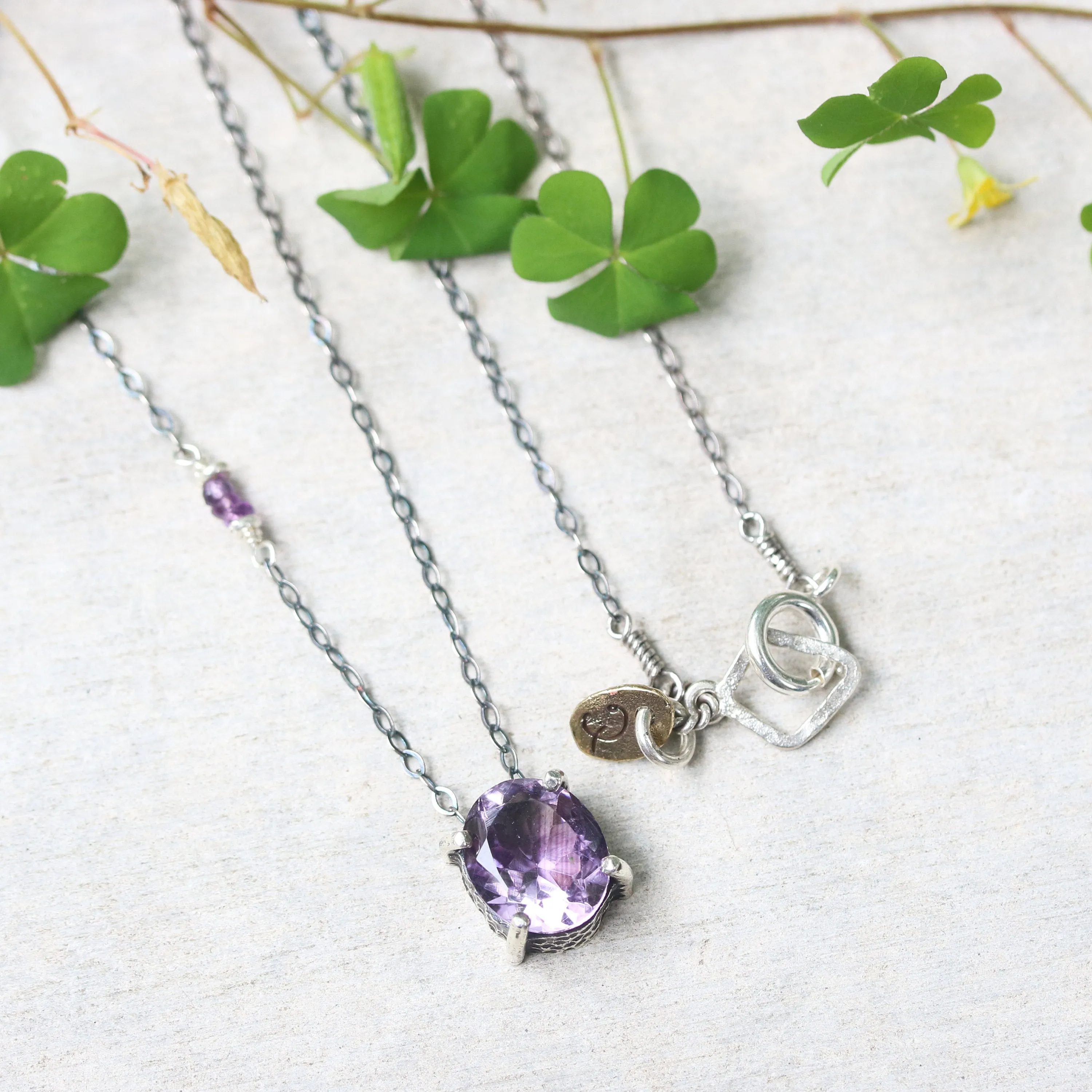 Oval Amethyst pendant necklace in silver bezel and prongs setting with amethyst beads secondary on oxidized sterling silver chain