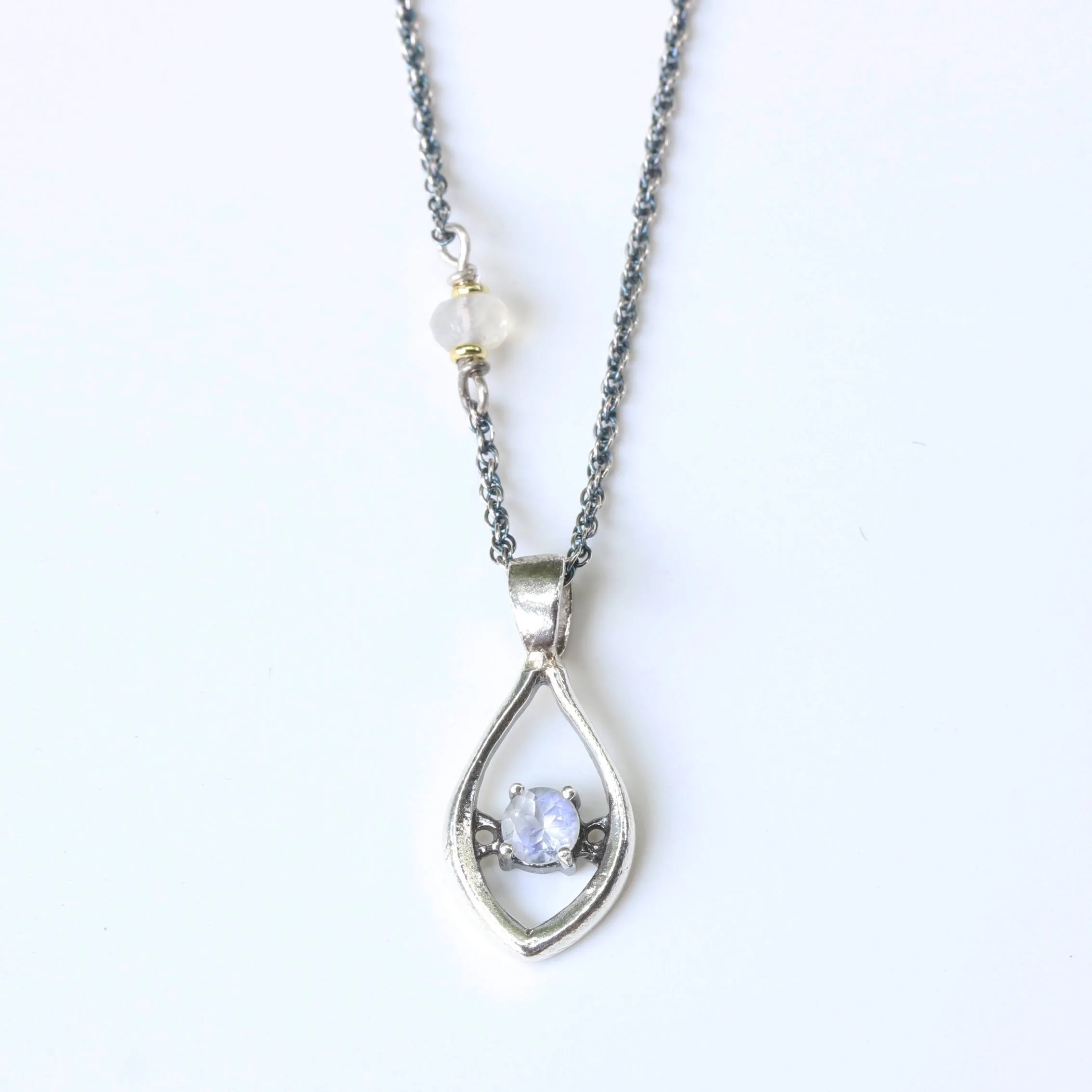Silver leaf shape necklace and round faceted moonstone at the center with moonstone beads secondary on oxidized sterling silver chain